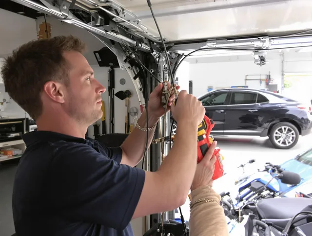 Bedford Garage Door Repair safety certified technician performing cable replacement in Bedford